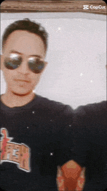 a man wearing sunglasses and a t-shirt that says ' chicago '