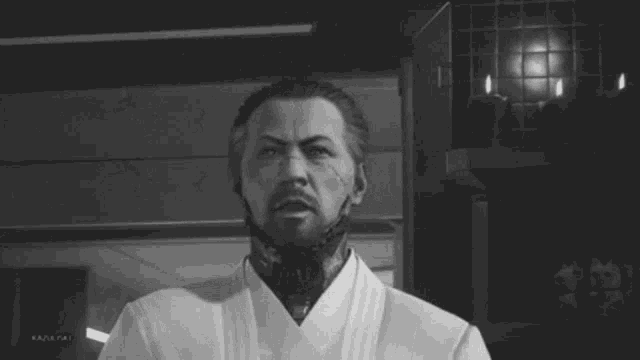 a black and white photo of a man with a beard wearing a white robe