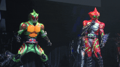a man in a green and orange costume with a red belt is dancing on a stage
