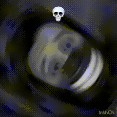 a close up of a person 's eye with a skull in the corner .
