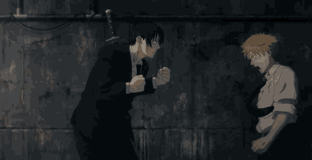 a man kicking another man in the face while wearing a white shirt with the letter k on it