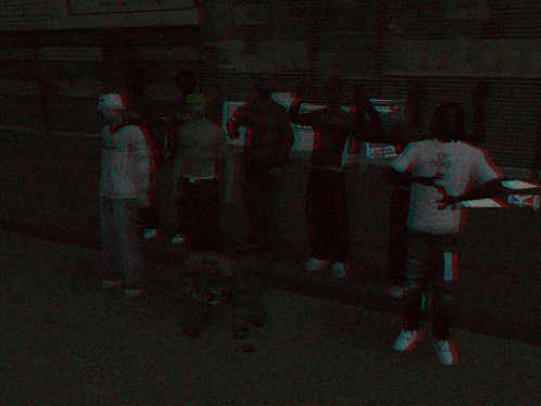 a group of people standing next to each other in a dark room with a sign that says ' a ' on it