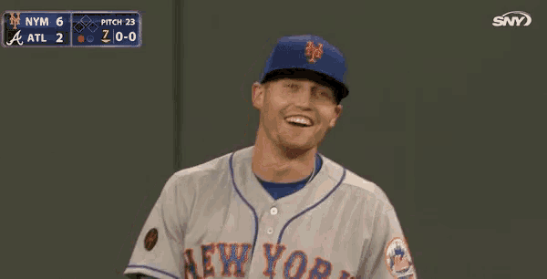 a baseball player for the new york mets holds his hand to his heart