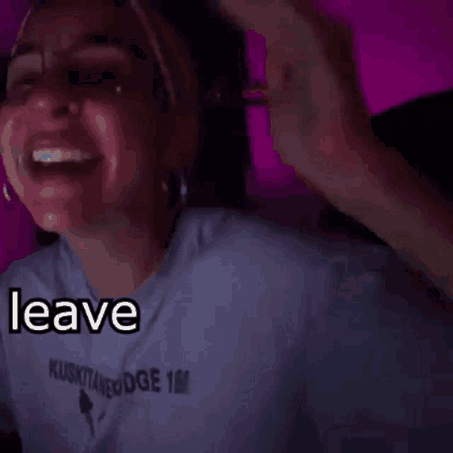 a woman wearing sunglasses and a white shirt with the words leave me the fuck on it