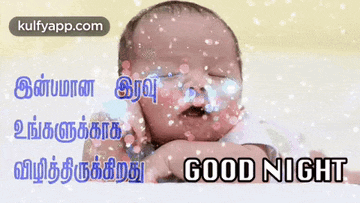 a baby is sleeping on a bed with the words good night in tamil