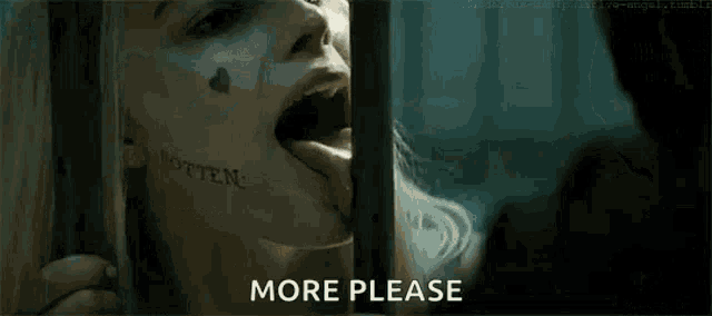 a woman with a tattoo on her face is behind bars in a jail cell and says `` more please '' .