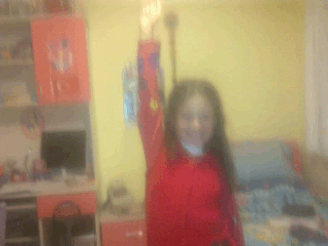 a blurry picture of a girl in a red shirt