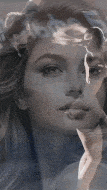 a double exposure of a woman 's face with a man 's face behind her