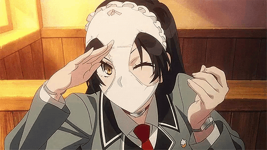 a girl in a suit and tie is wearing a white mask on her face .
