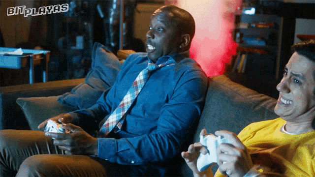 two men sitting on a couch playing a video game with the words bitplayers visible
