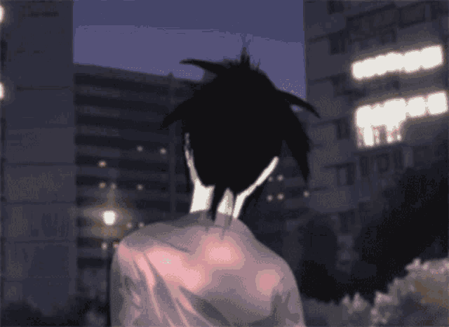 a person with black hair is standing in front of a building with a lot of lights