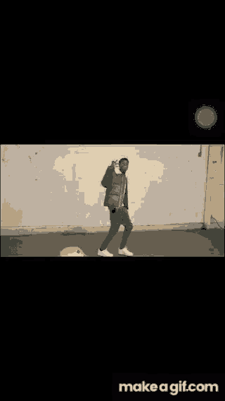 a man is standing in front of a wall with fire coming out of it and the words make a gif.com at the bottom