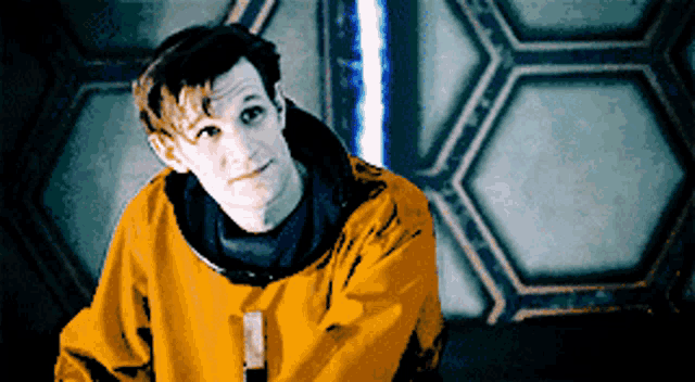 a man wearing a yellow jacket with a black hood
