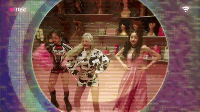 three women are dancing in a circle with the word rec on the bottom right