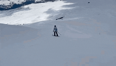 a person is skiing down a snowy mountain