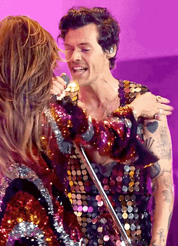 a man and a woman are hugging on a stage