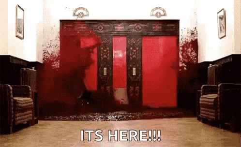 a bloody hallway with a red door and the words `` it 's here '' .