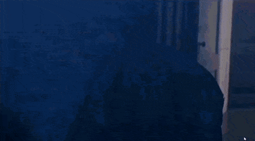 a person is standing in a room with smoke coming out of the ceiling .
