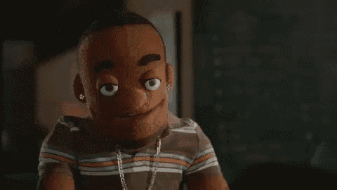 a close up of a puppet wearing a striped shirt and earrings .