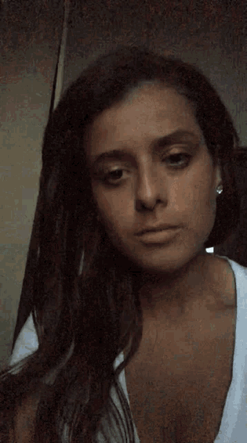 a woman with her eyes closed is wearing a white t-shirt
