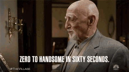 a man in a suit says " zero to handsome in sixty seconds " in front of a mirror