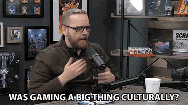 a man is talking into a microphone with the words was gaming a big thing culturally