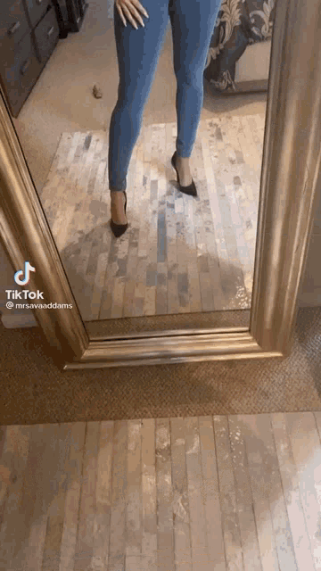 a woman is taking a picture of herself in front of a mirror