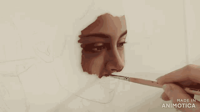 a person is painting a woman 's face with a brush and the words made in animotica on the bottom