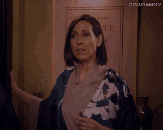 a man and a woman are standing next to each other in a room .
