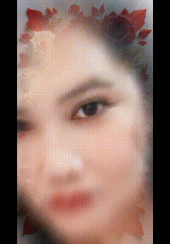 a close up of a woman 's face with a flower on her head