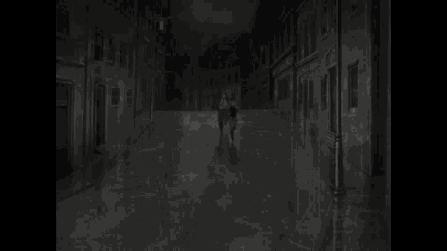 a man in a suit and tie is running behind a woman in a black jacket