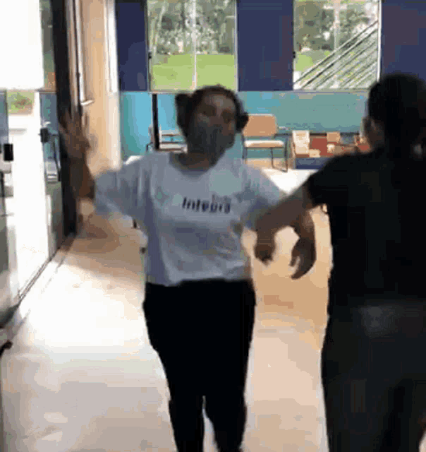 a woman wearing a white shirt with integrity written on it