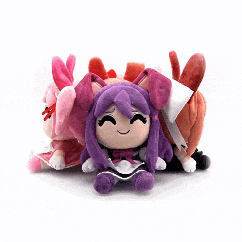 two stuffed dolls are sitting next to each other