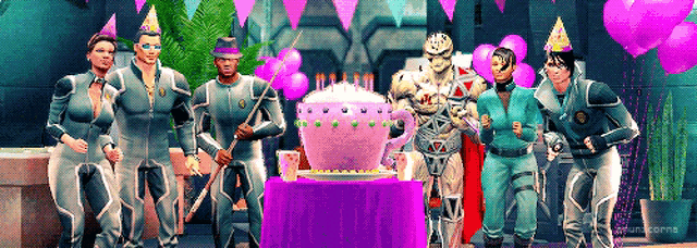 a group of people wearing party hats standing around a cake