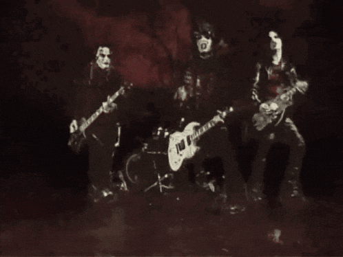 a black and white photo of a group of people playing guitars
