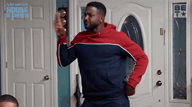 a man is dancing in front of a door that says tyler perry house of payne