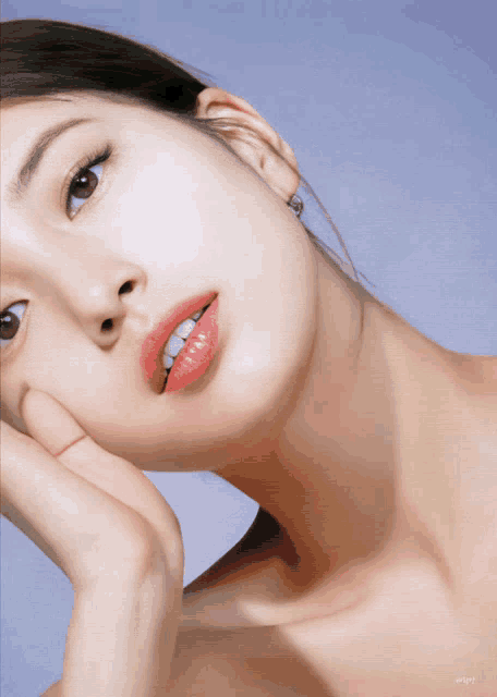 a close up of a woman 's face with a purple background and the word enjoy on the bottom