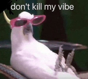 a white cockatoo wearing pink sunglasses and horns is sitting on a tree branch .