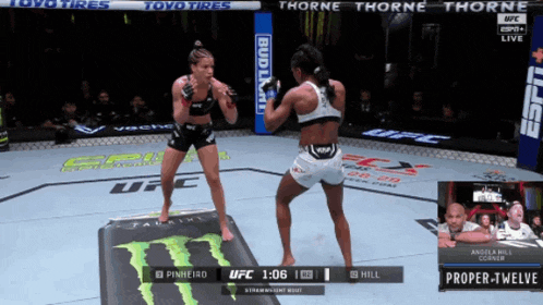 two women are fighting in a ufc ring with a bud light banner in the background