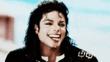 a close up of a man 's face with a smile on his face and a black jacket with the letter o on it