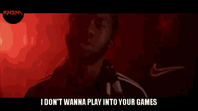 a man singing into a microphone with the words i don 't wanna play into your games