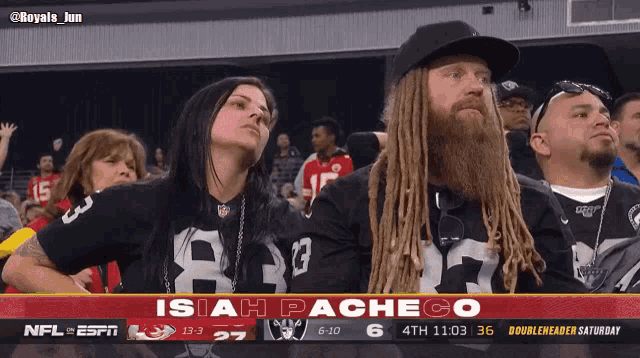 a man with dreadlocks is watching a football game with the name isiah pacheco at the top