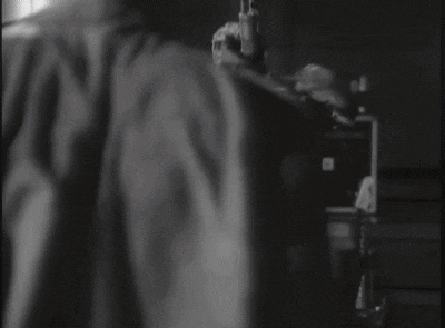 a man without a shirt is standing in front of a microphone