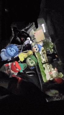 a group of inside out characters are sitting in the back seat of a car