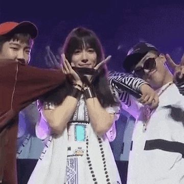 a group of people are standing next to each other on a stage and making funny faces .