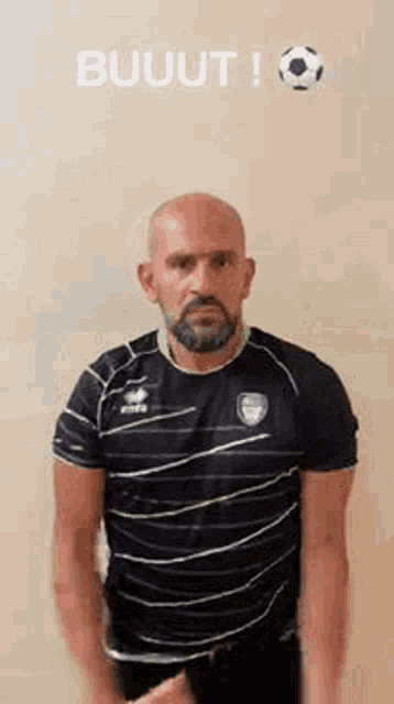 a bald man with a beard wearing a black and green striped shirt is making a funny face .