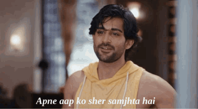 a man wearing a yellow tank top with the words apne aap ko sher samjhta hai on the bottom
