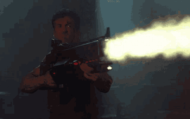 a man holding a gun with smoke coming out of the barrel