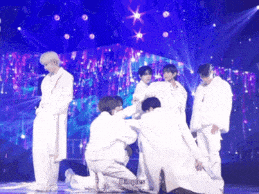 a group of people on a stage with the word dimples on the bottom left