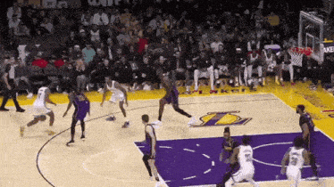 a basketball game is being played on a court that has the lakers logo on it